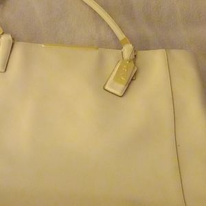 A large coach bag . 13inchs by 12inchs In excellent condition  Baige in color
